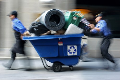 Driver loading a skip with safety cones in place
